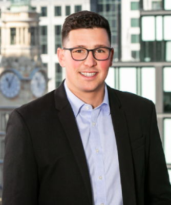 Mid profile shot of man wearing formal wear against building background 