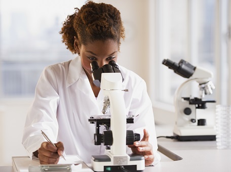 Scientist looking into microscope