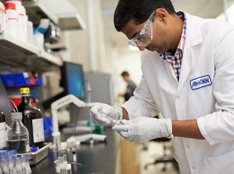Scientist wearing lab wear and analysing sample